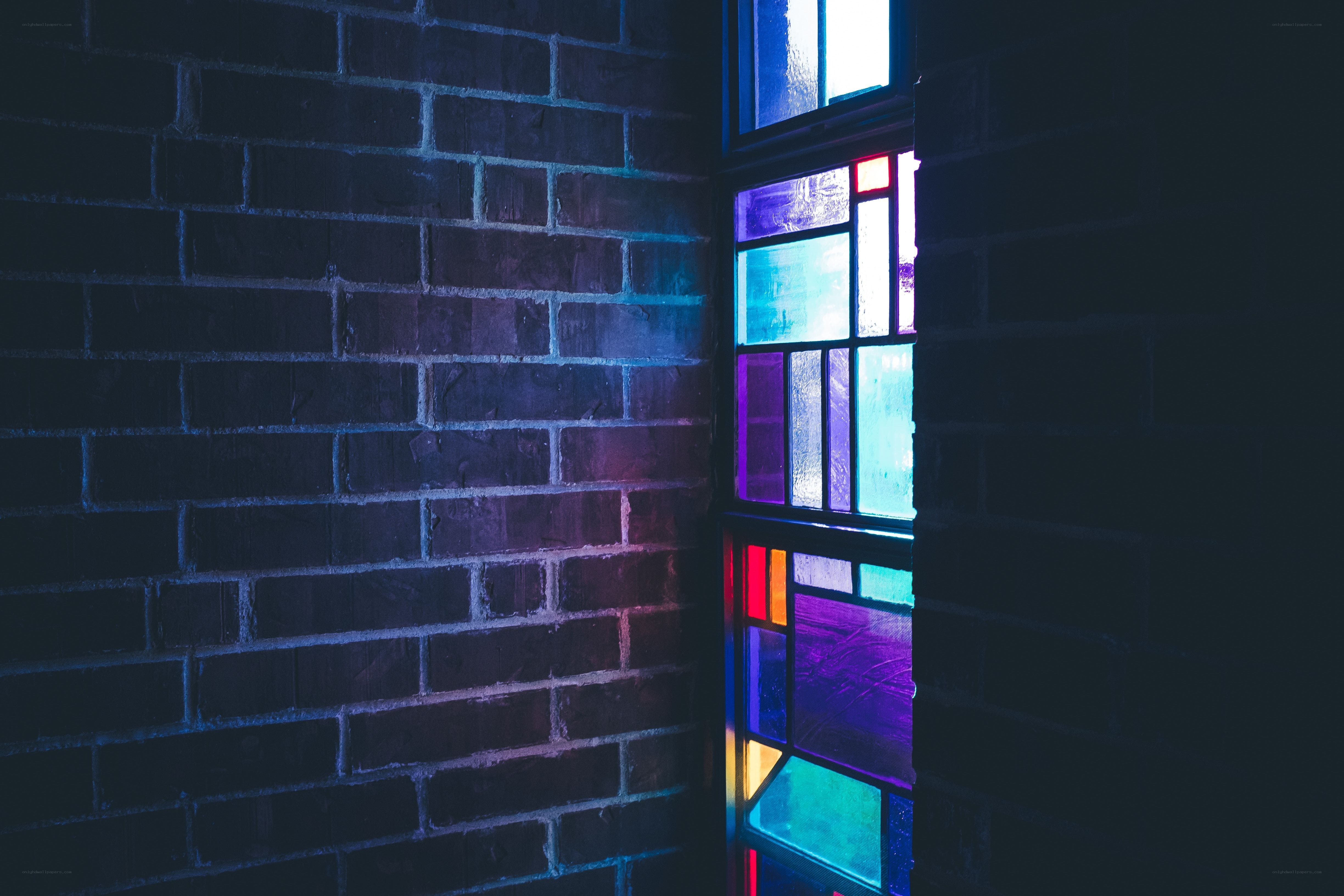 stained glass window in brick wall