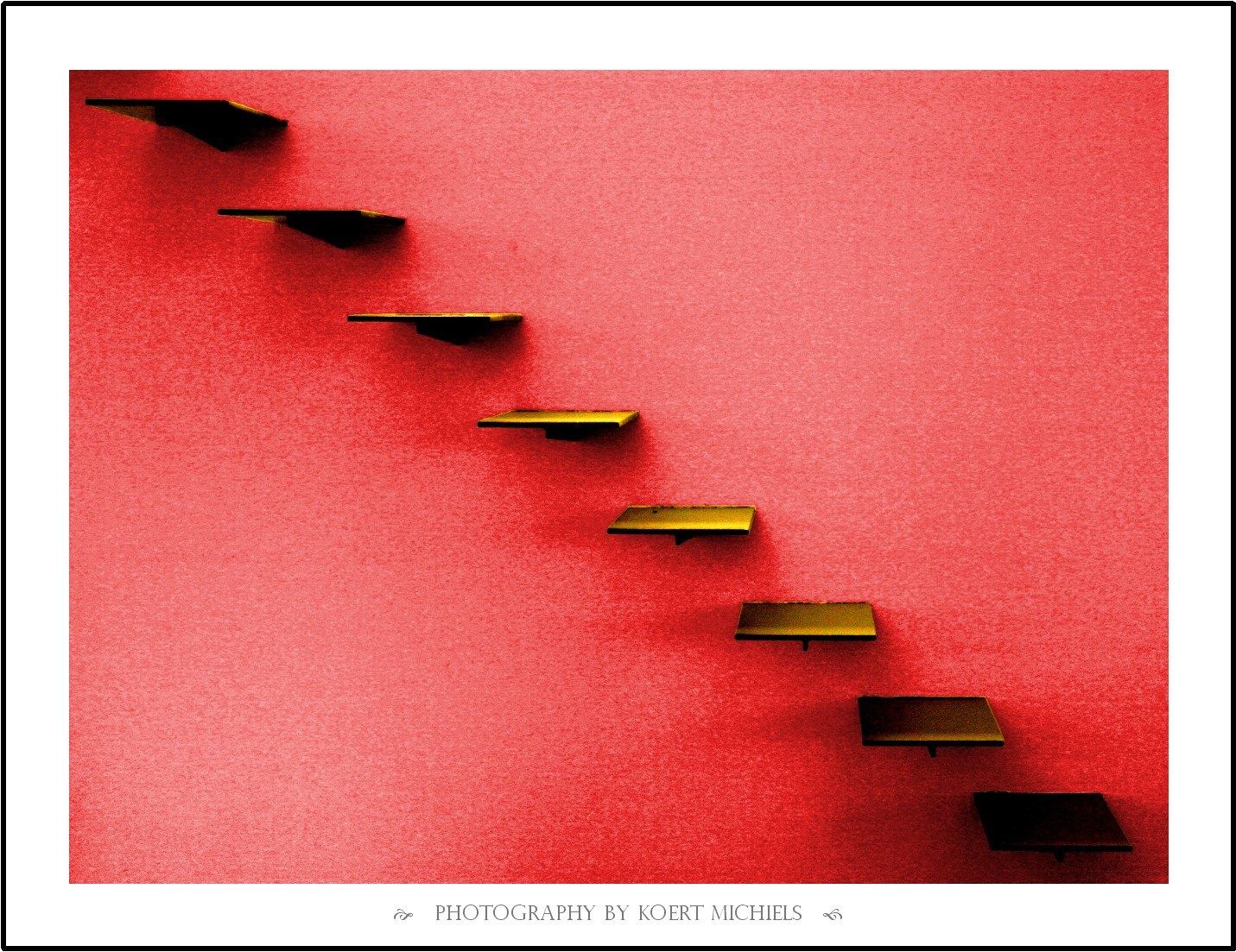 Staircase shelves on red wall