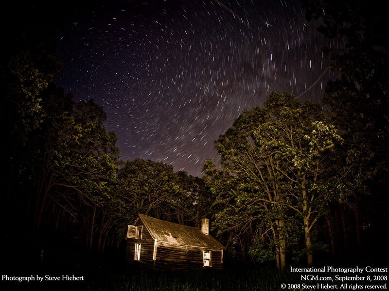 Star trails over a cabin