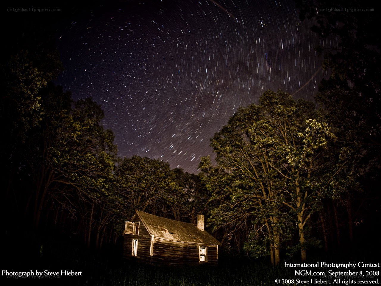 Star trails over a cabin