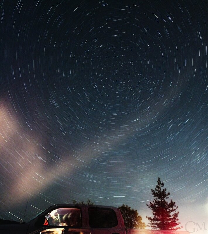 Star trails over a car