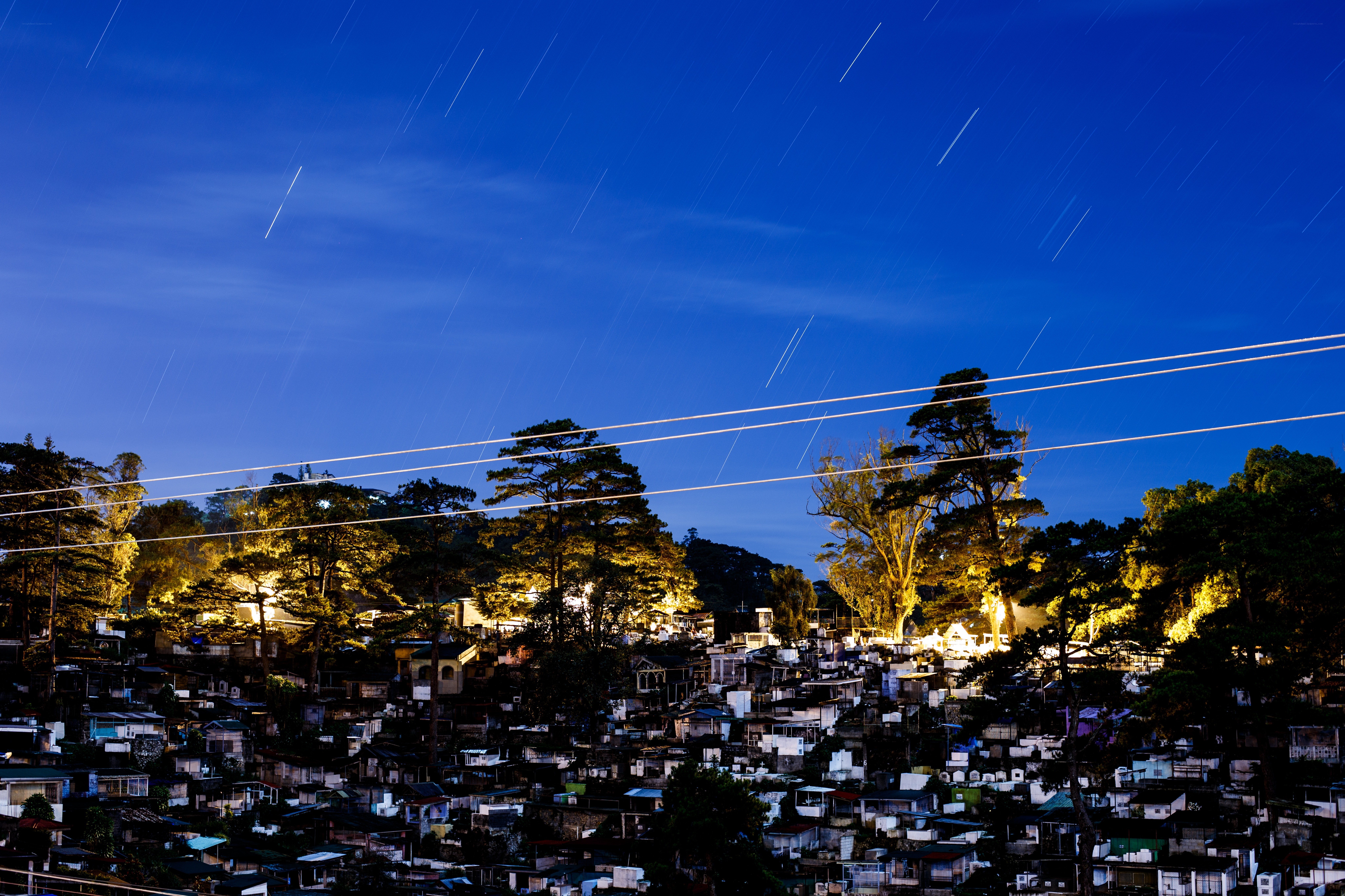 Star trails over a cemetery at night