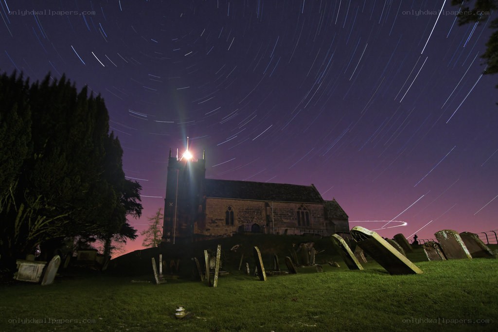 Star trails over a church