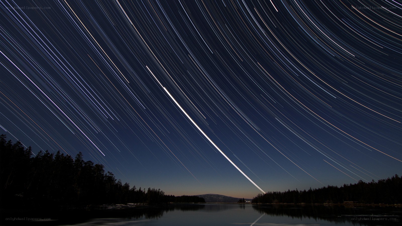 Star trails over a lake