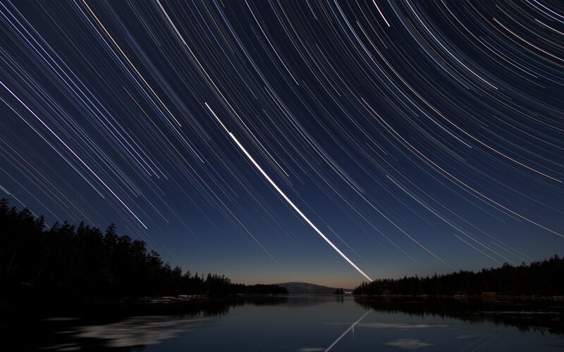 Star trails over a lake