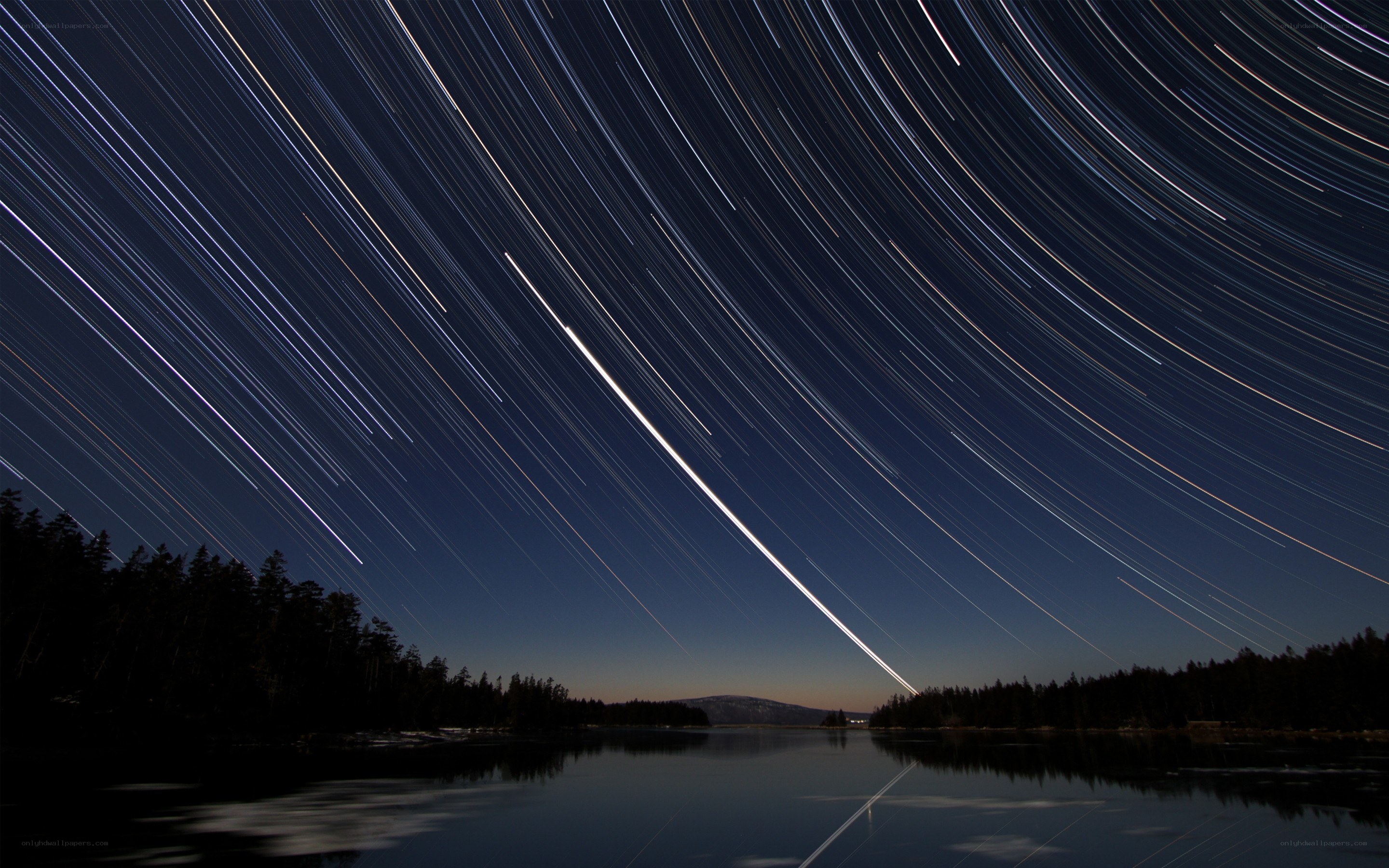 Star trails over a lake
