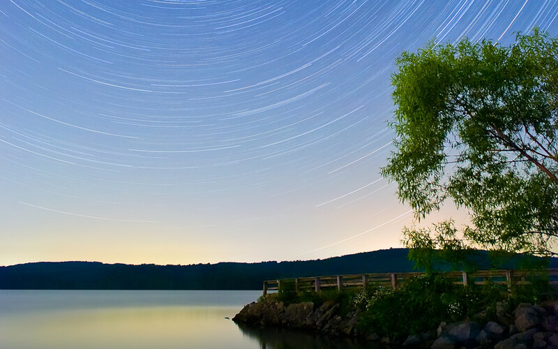 Star trails over a lake