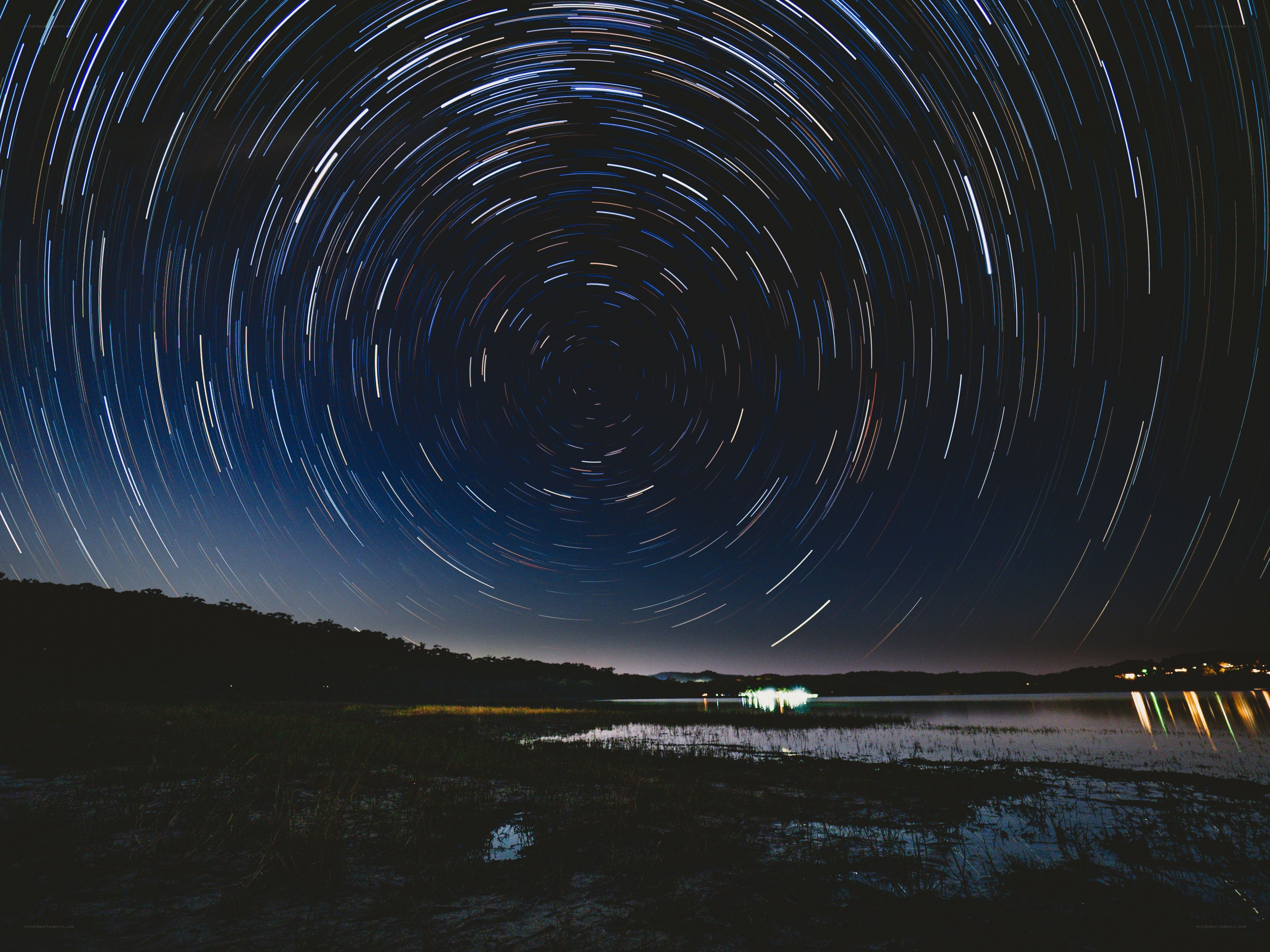 Star trails over a lake