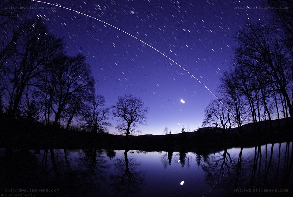 Star trails over a lake