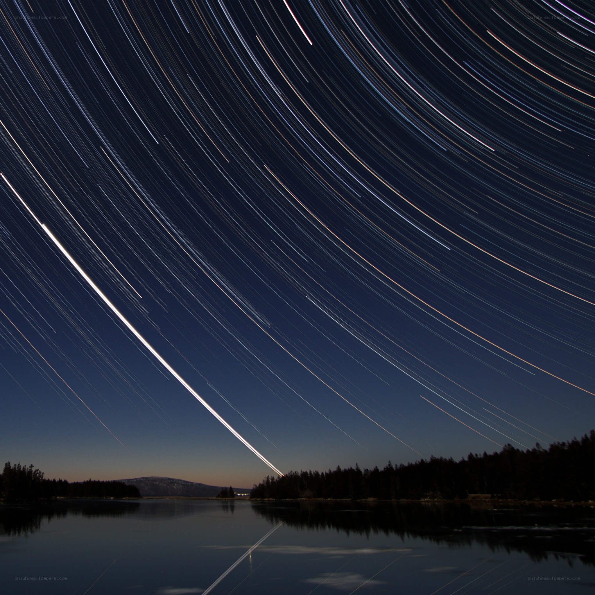 Star trails over a lake