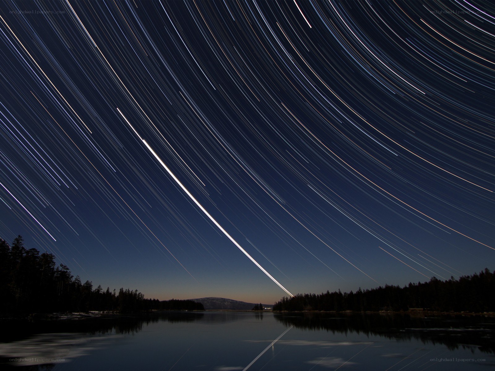 Star trails over a lake