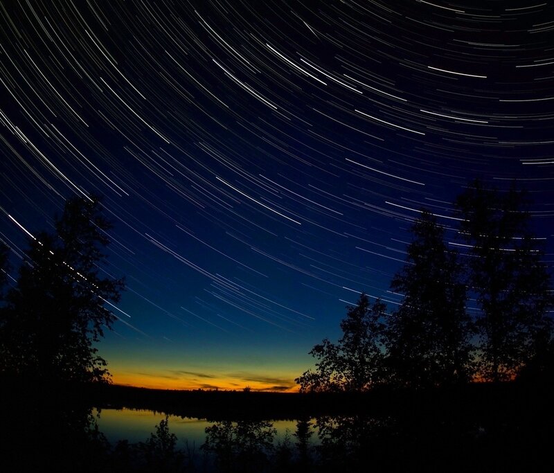 Star trails over a lake