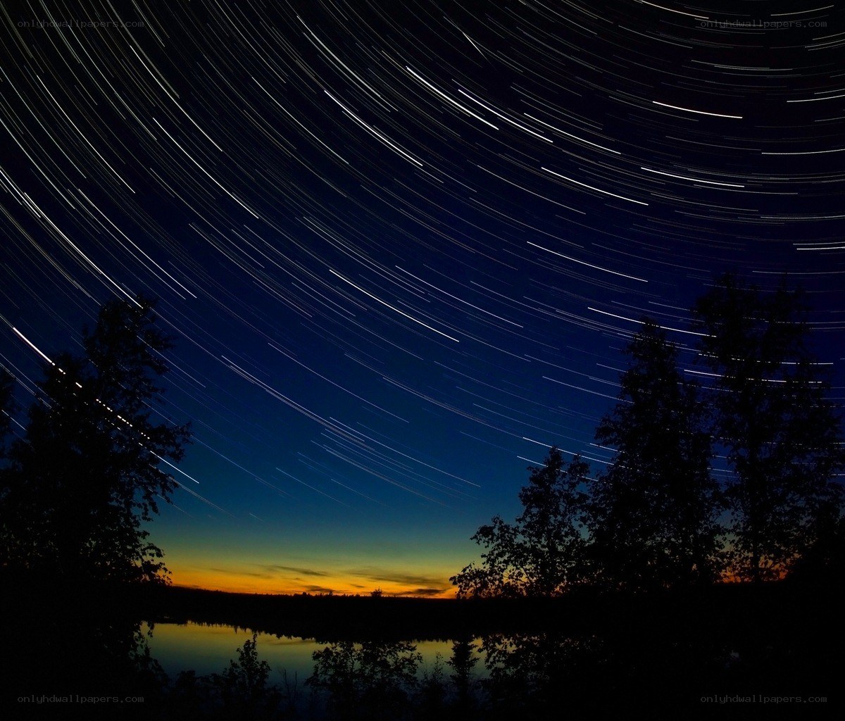 Star trails over a lake