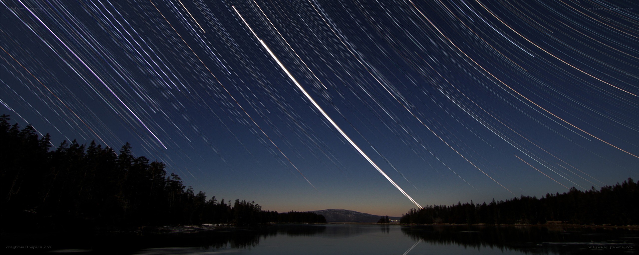 Star trails over a lake