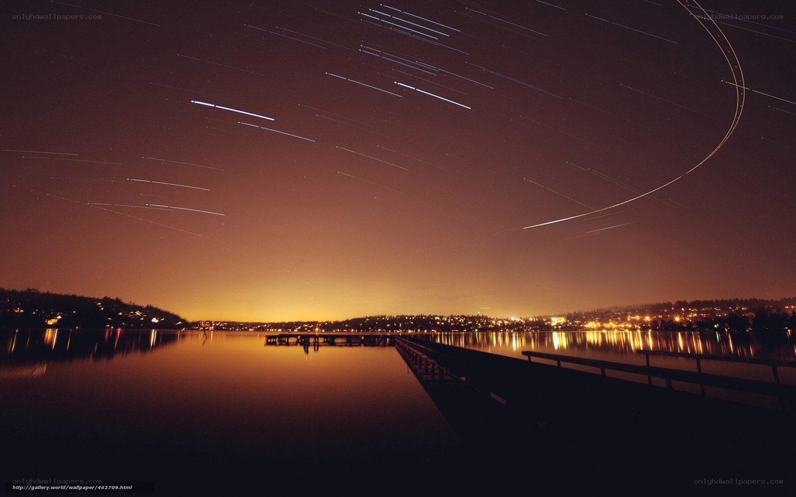 Star trails over a lake at night