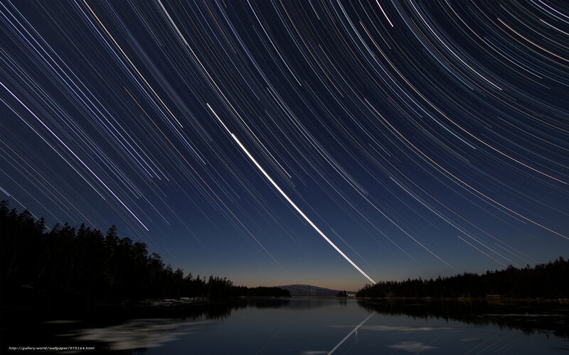 Star trails over a lake