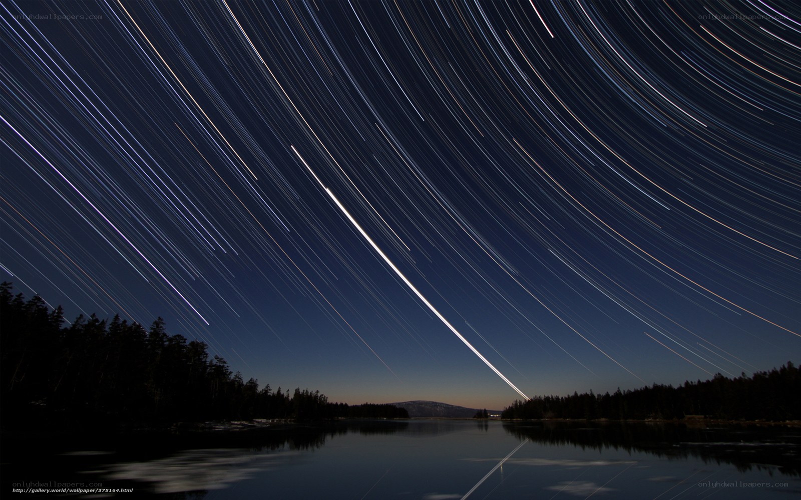 Star trails over a lake