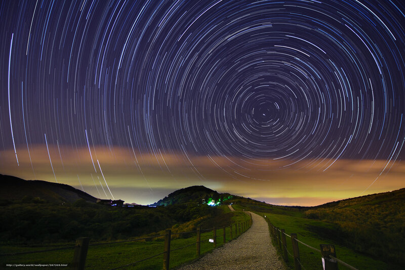 Star trails over a mountain path
