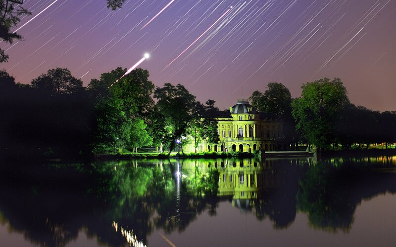 Star trails over a palace at night