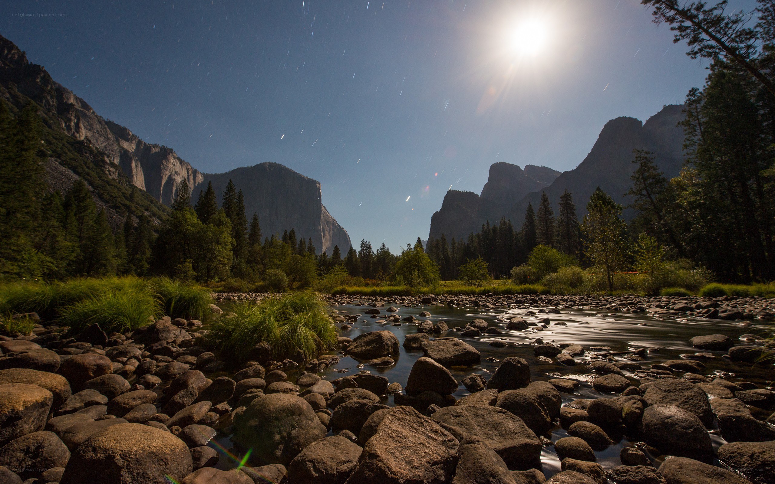 Star trails over a river at night
