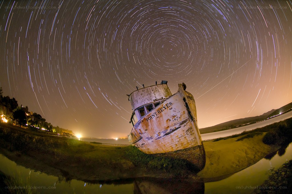star trails over a shipwreck