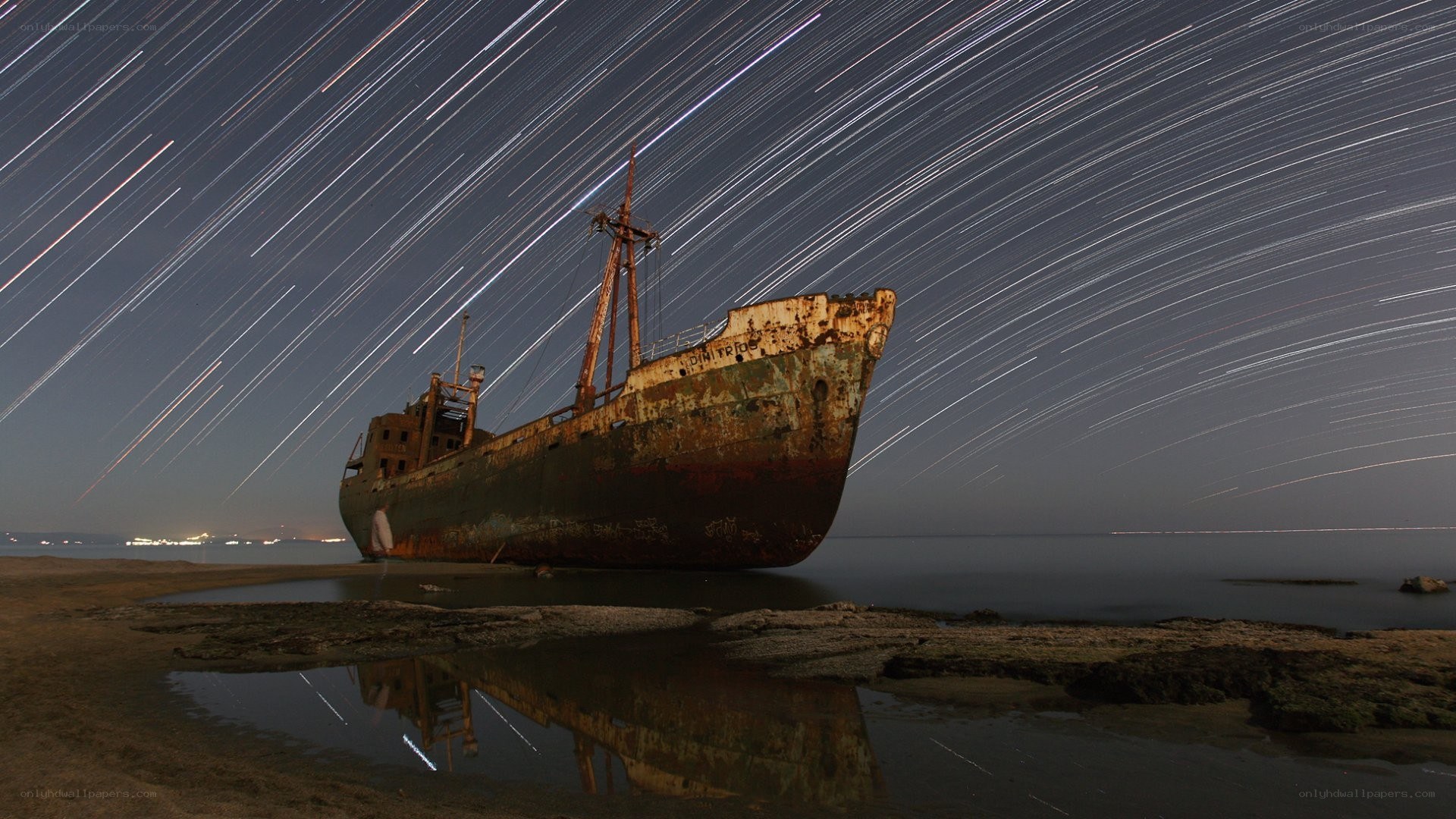 Star trails over a shipwreck