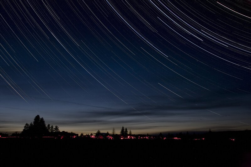 Star trails over a town