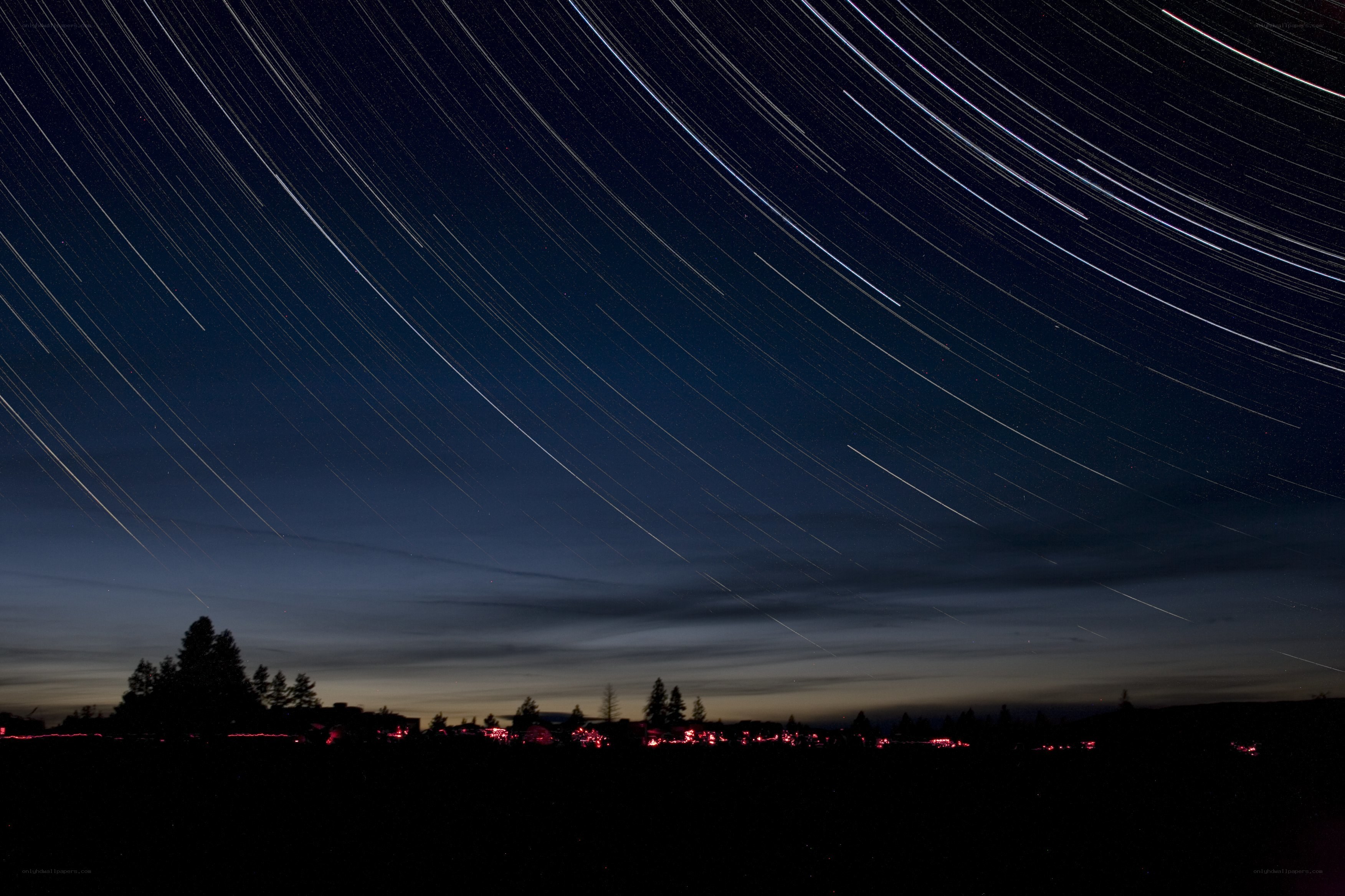 Star trails over a town