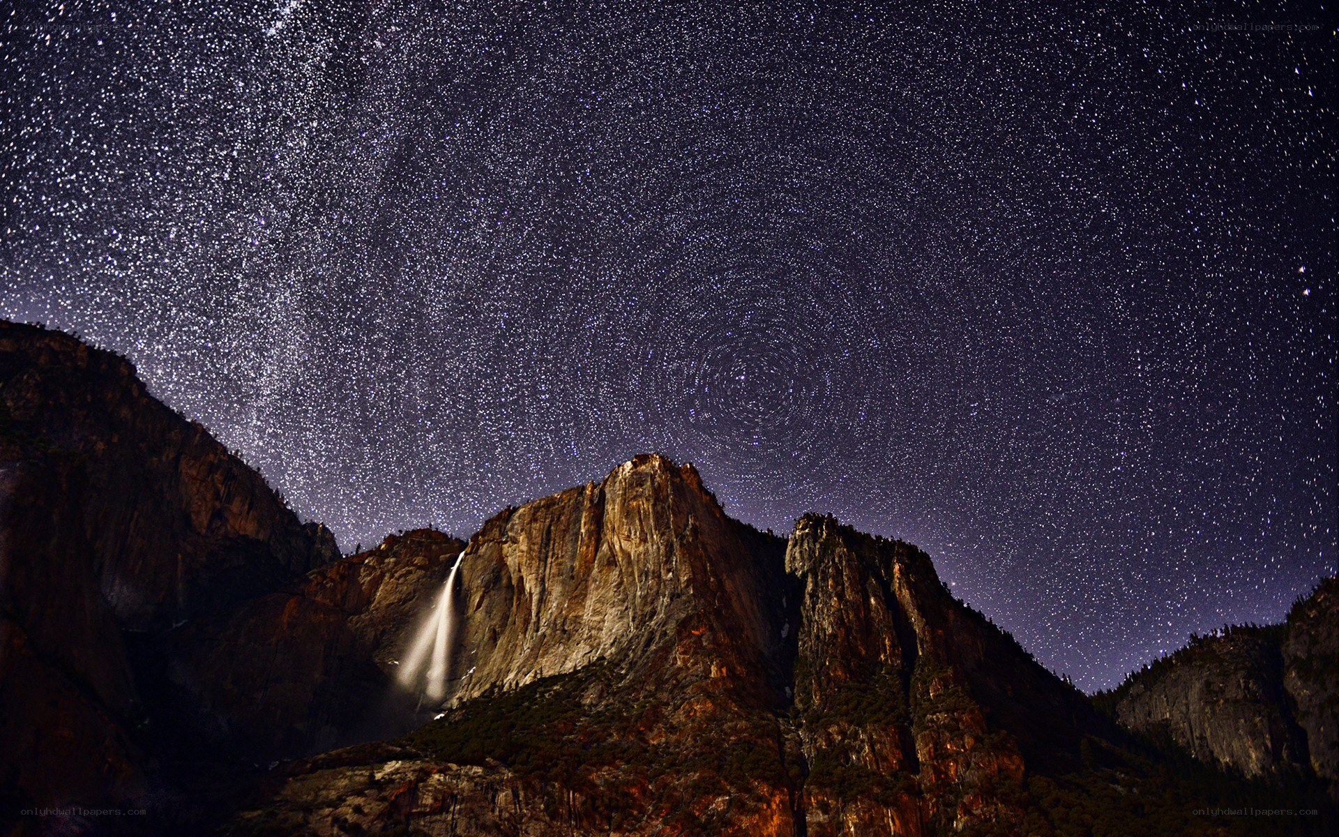 Star trails over a waterfall