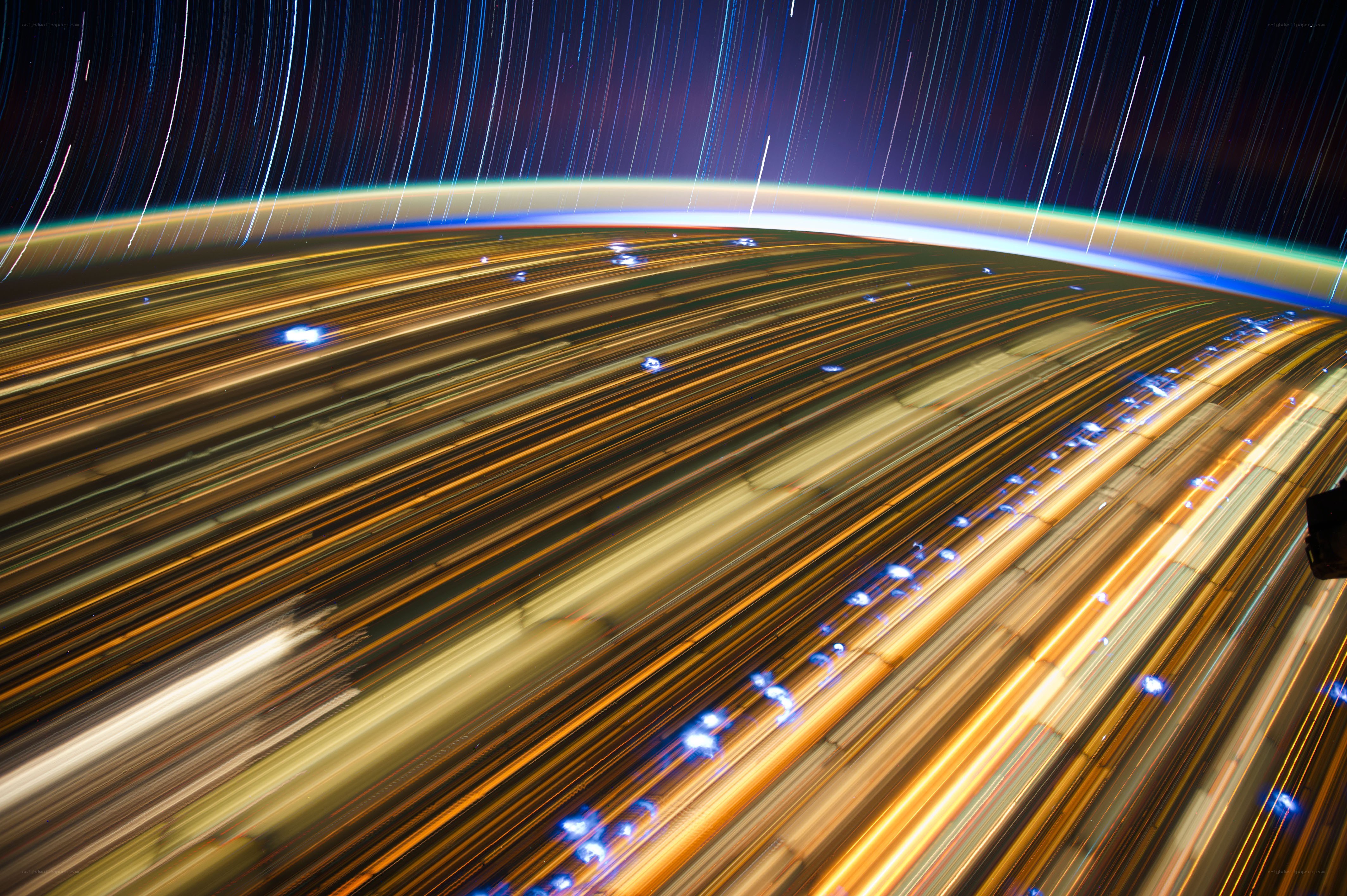 Star trails over city lights
