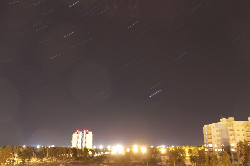 star trails over city skyline