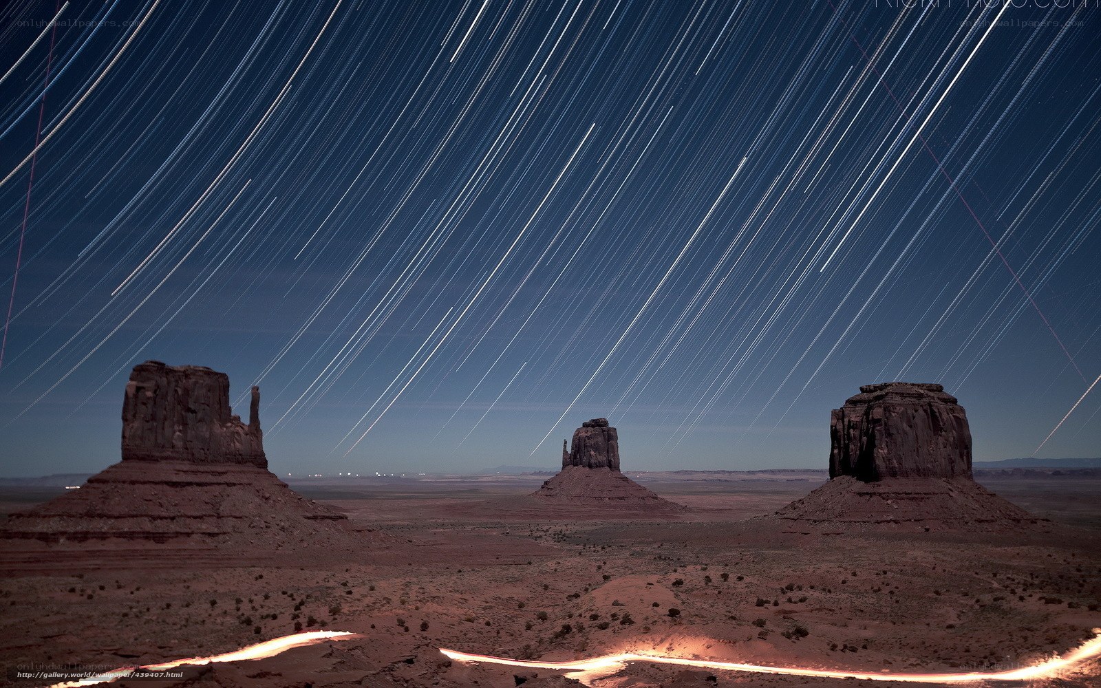 Star trails over desert rock formations