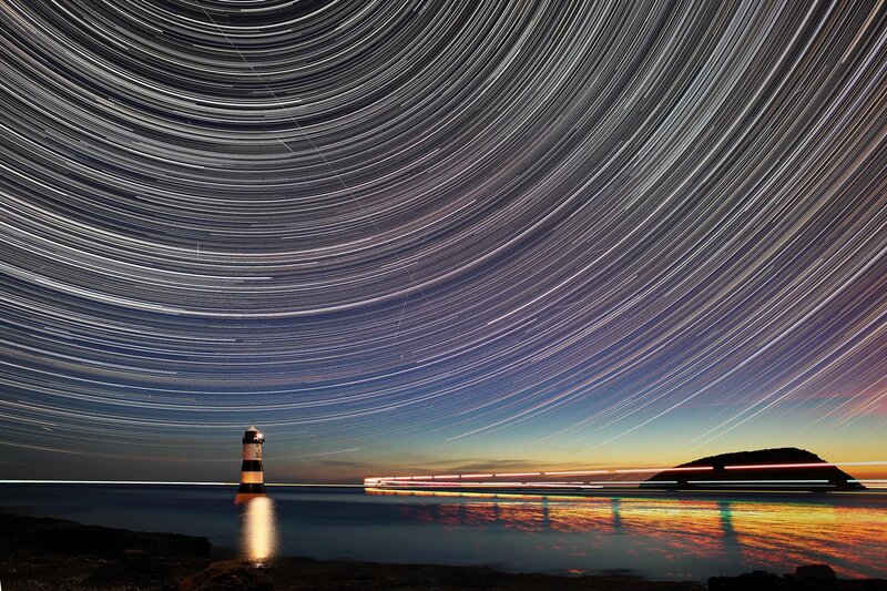 Star trails over lighthouse