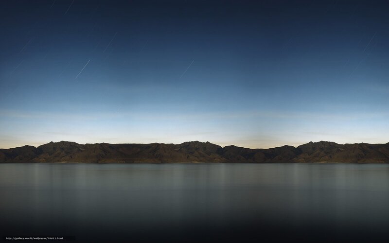 Star trails over mountain lake