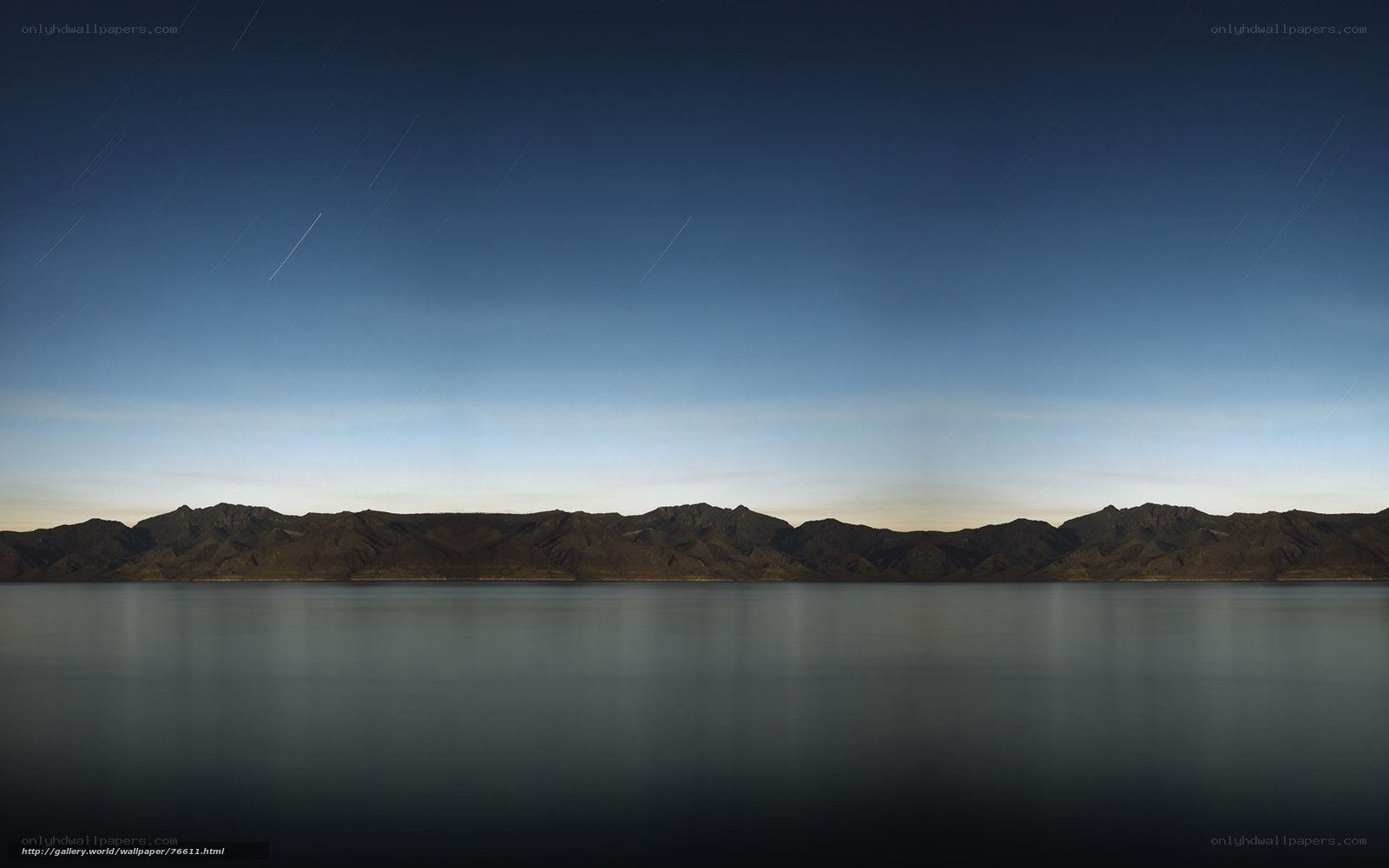 Star trails over mountain lake