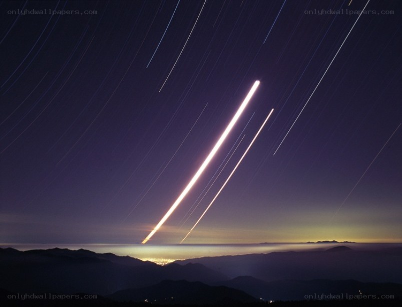 Star trails over mountain landscape