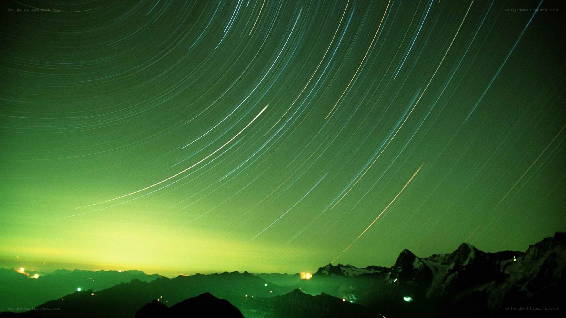 Star trails over mountain peaks