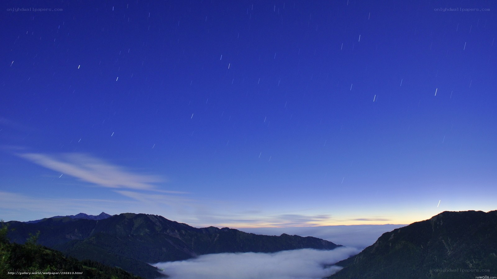 Star trails over mountain peaks