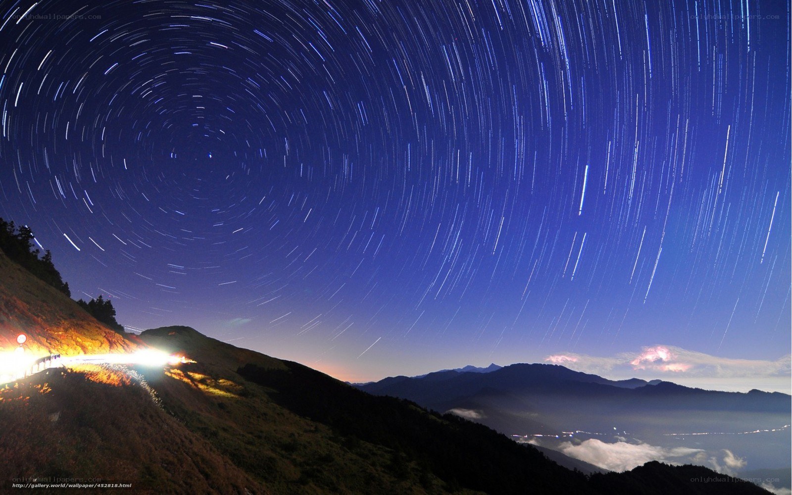 Star trails over mountain road