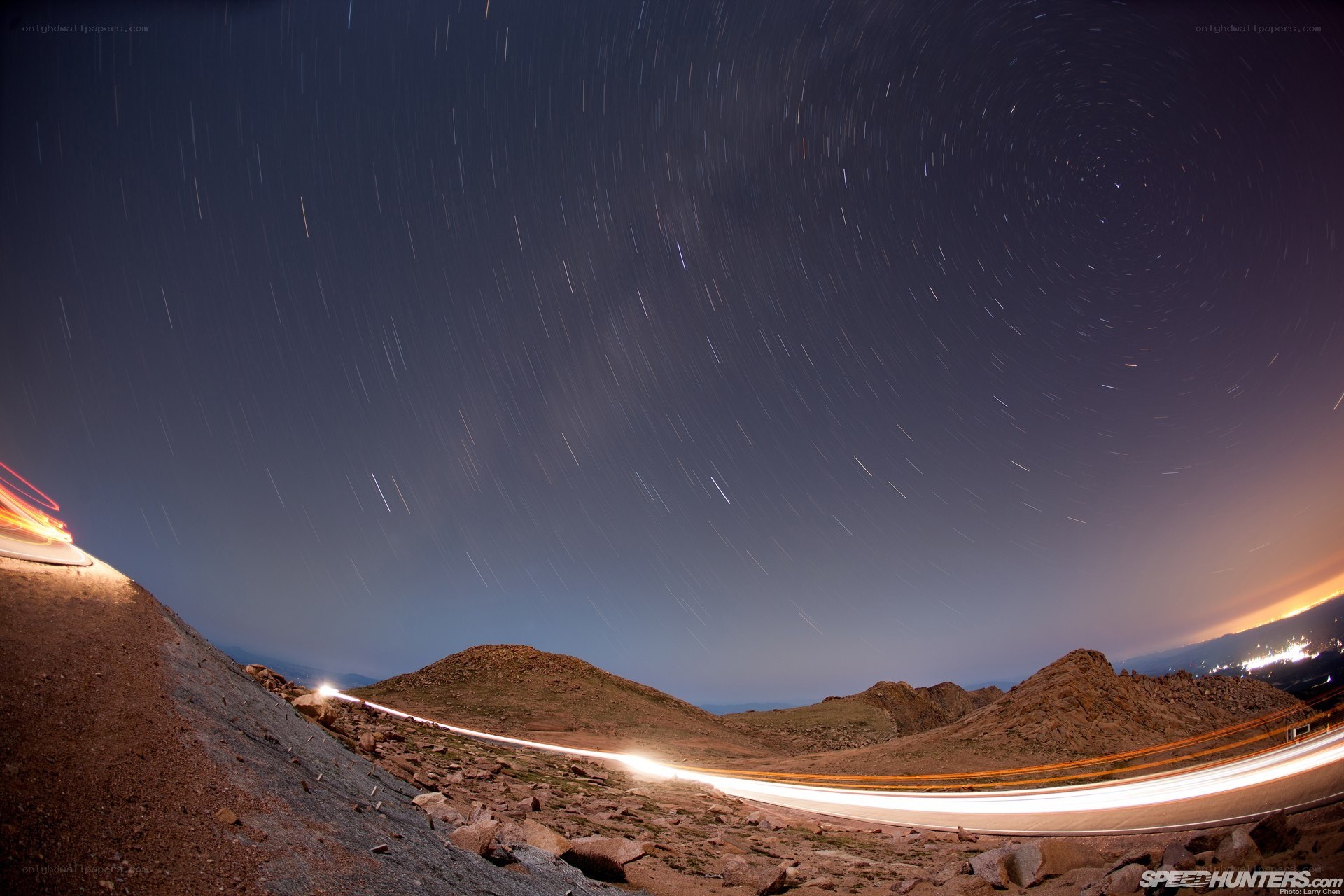 Star trails over mountain road