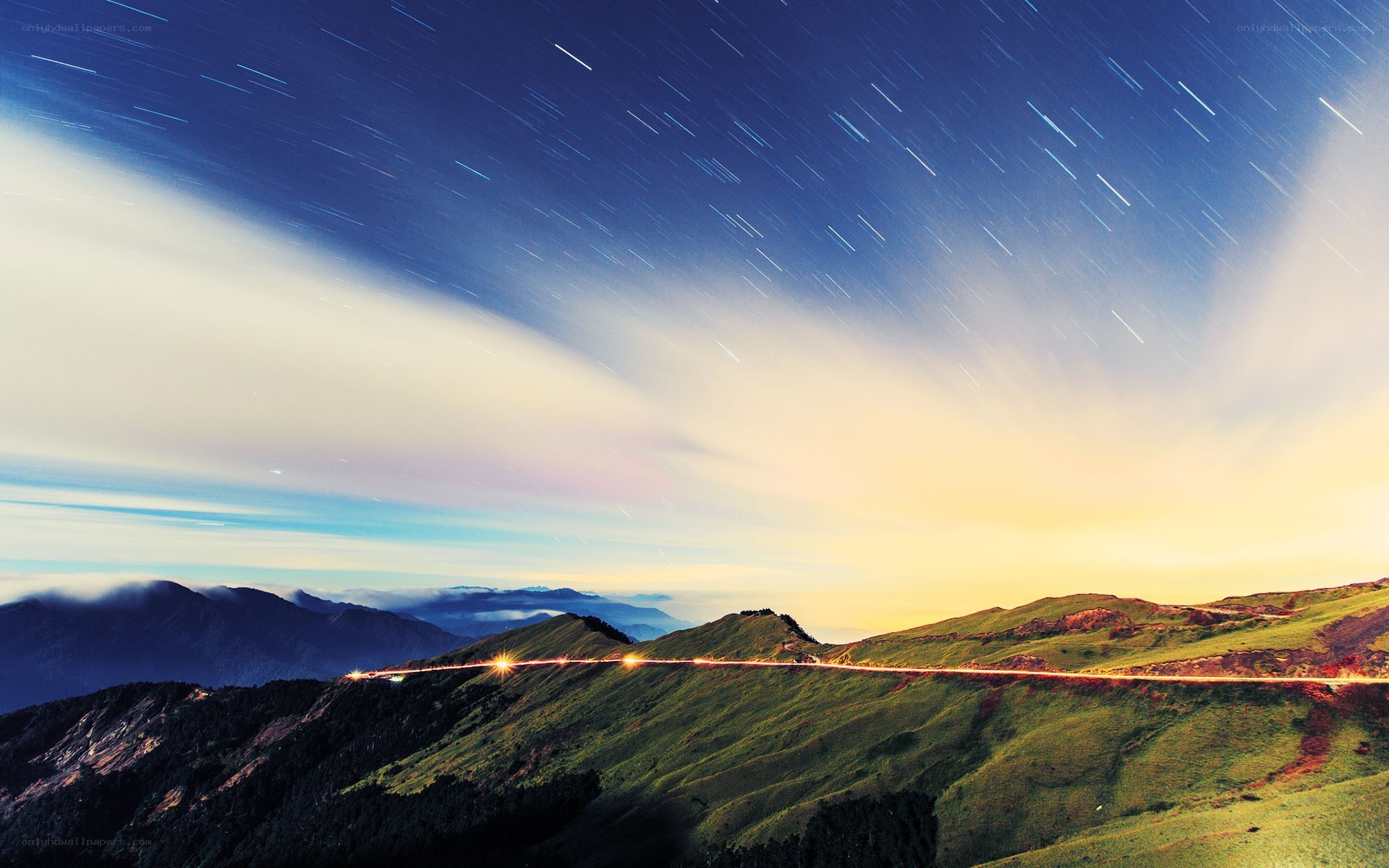 Star trails over mountain road