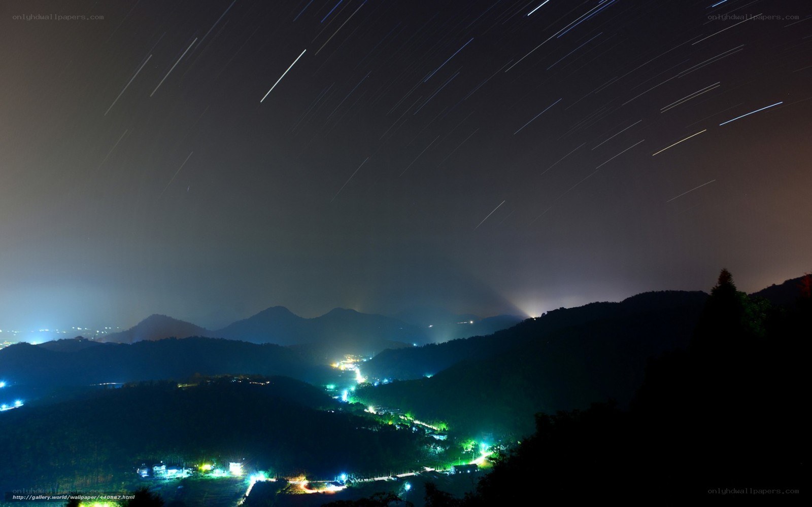 Star trails over mountain village