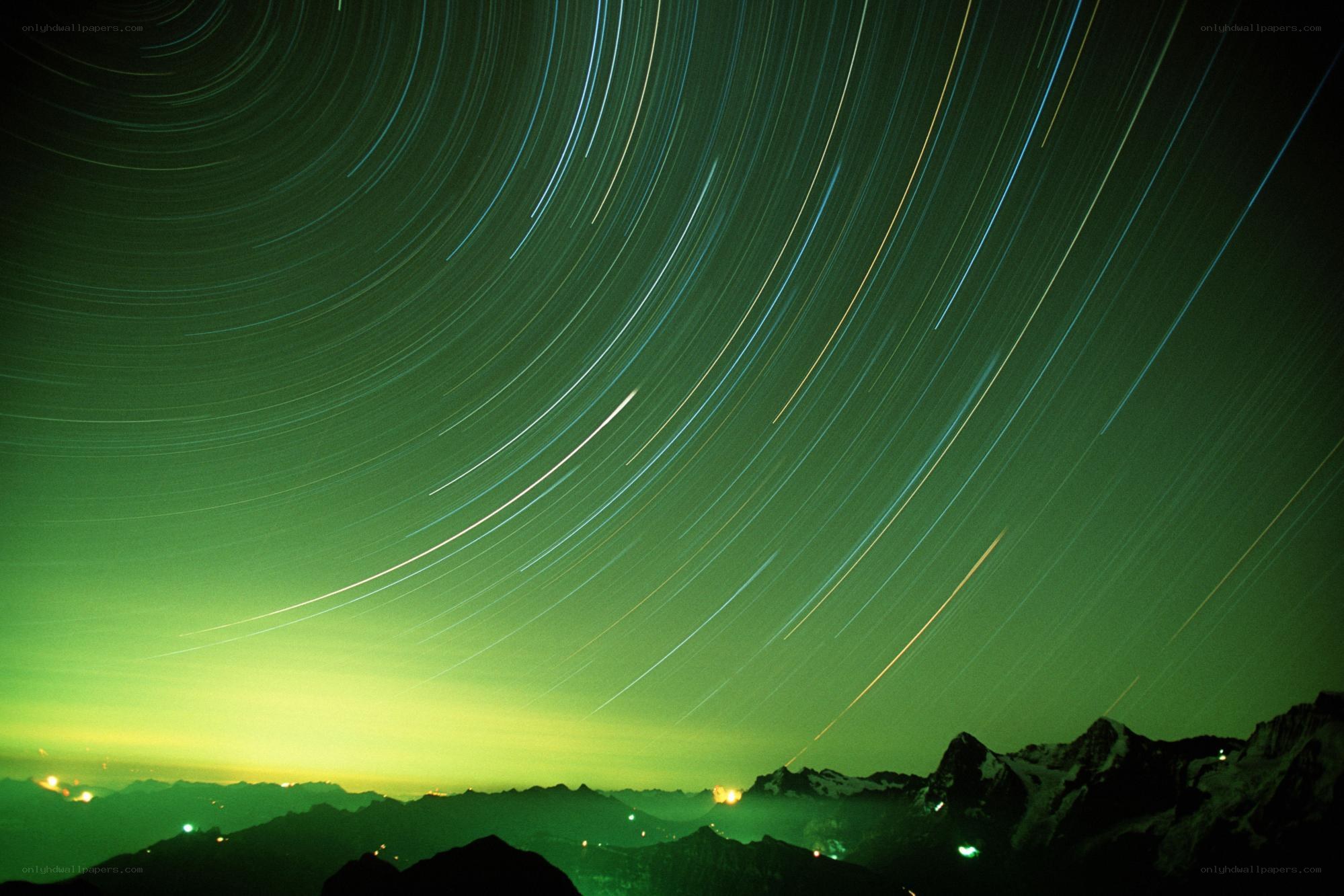 Star trails over mountains