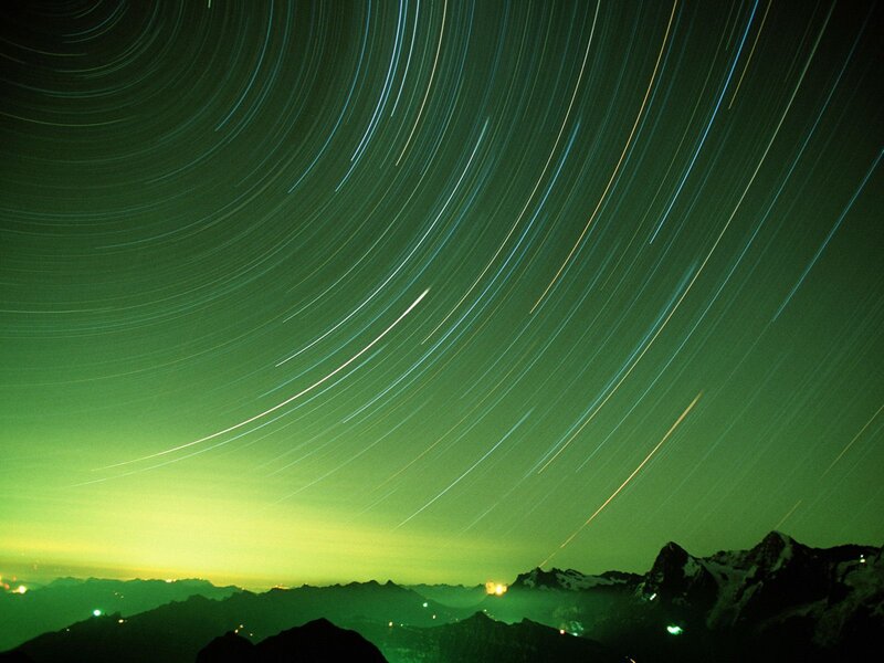 Star trails over mountains