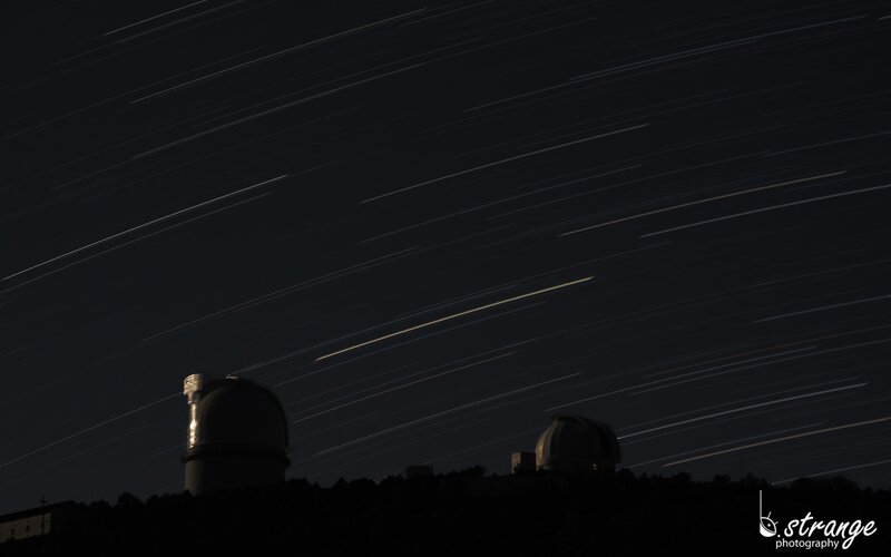 Star trails over observatory domes