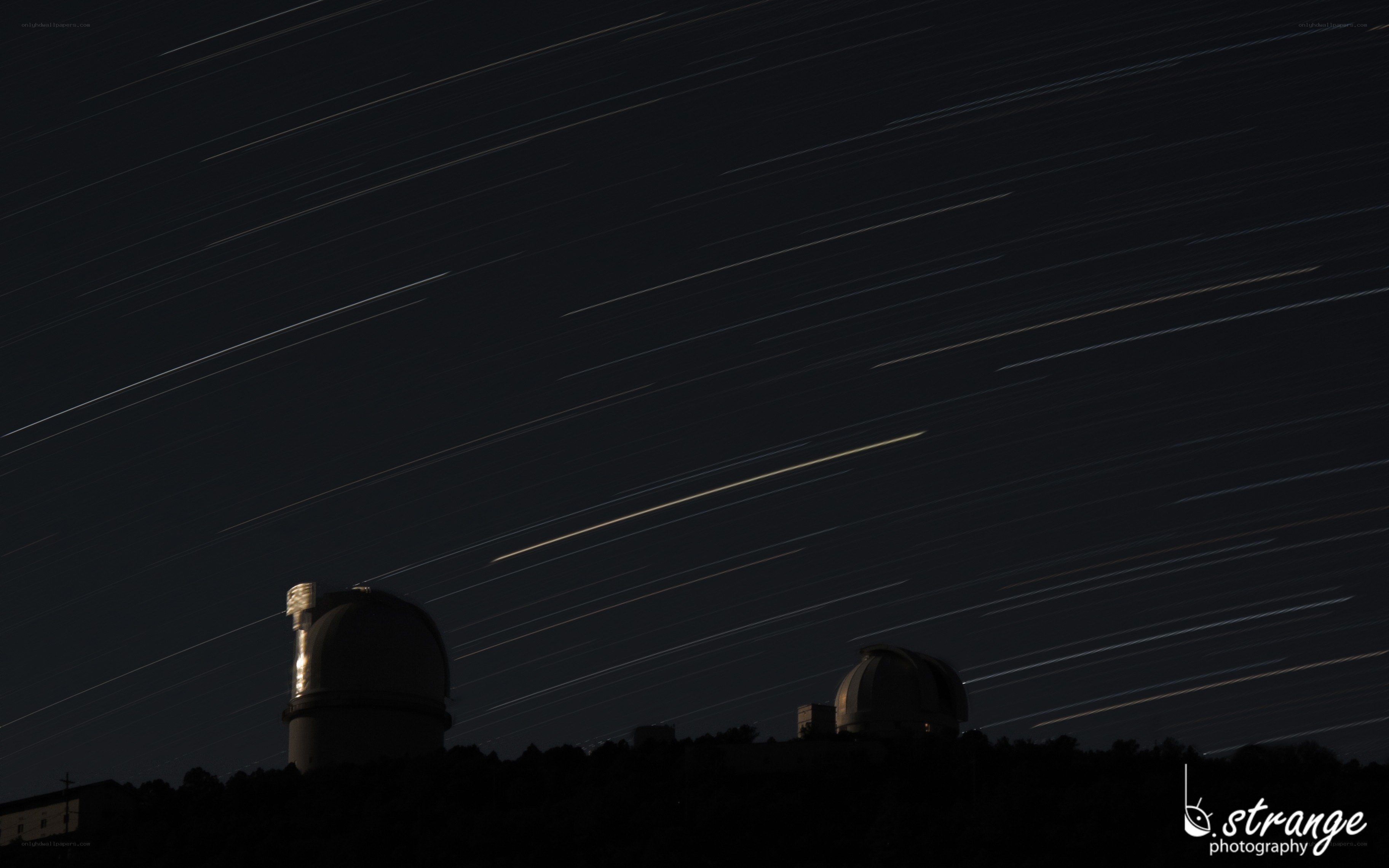 Star trails over observatory domes