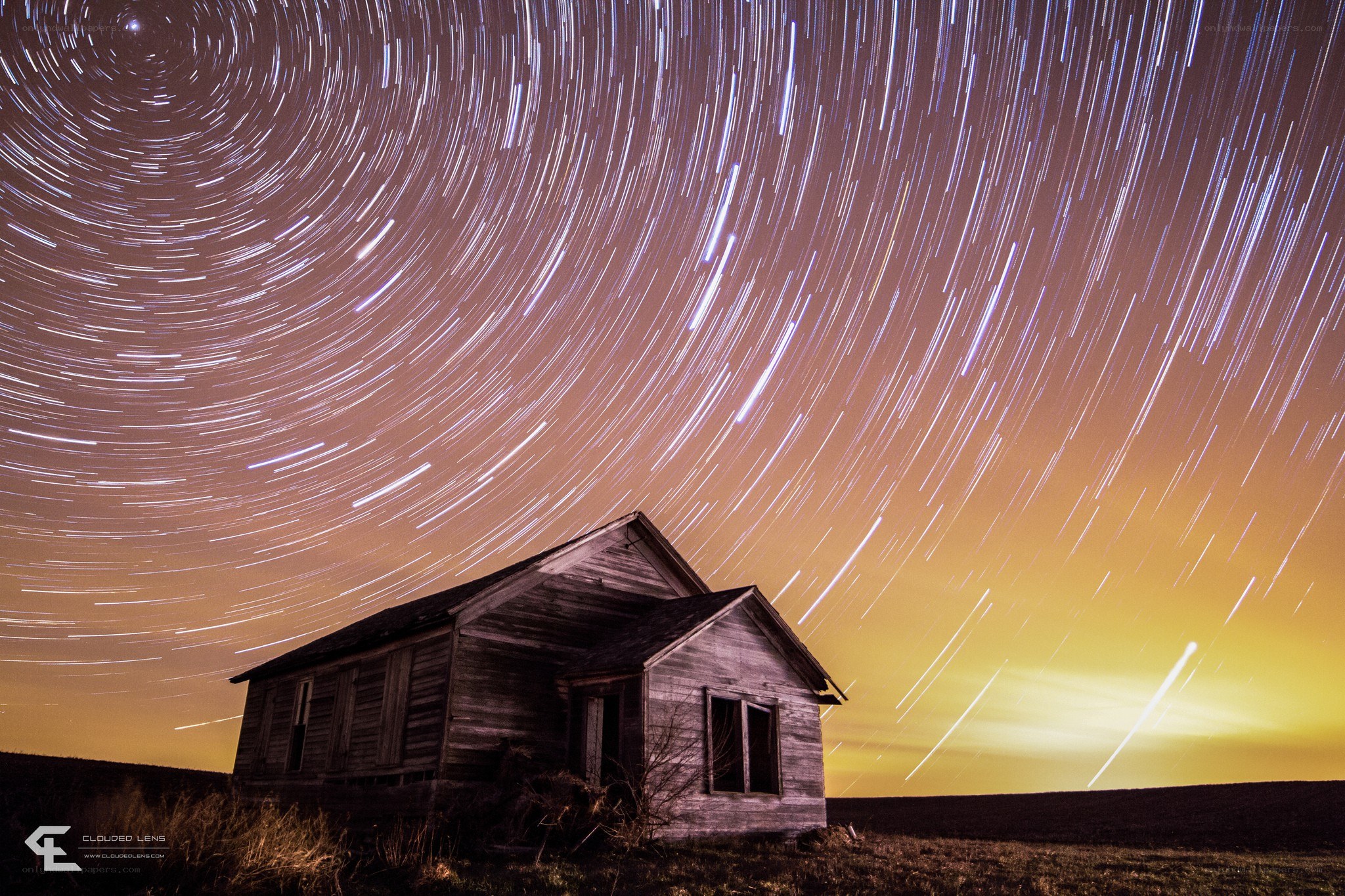 Star trails over old house