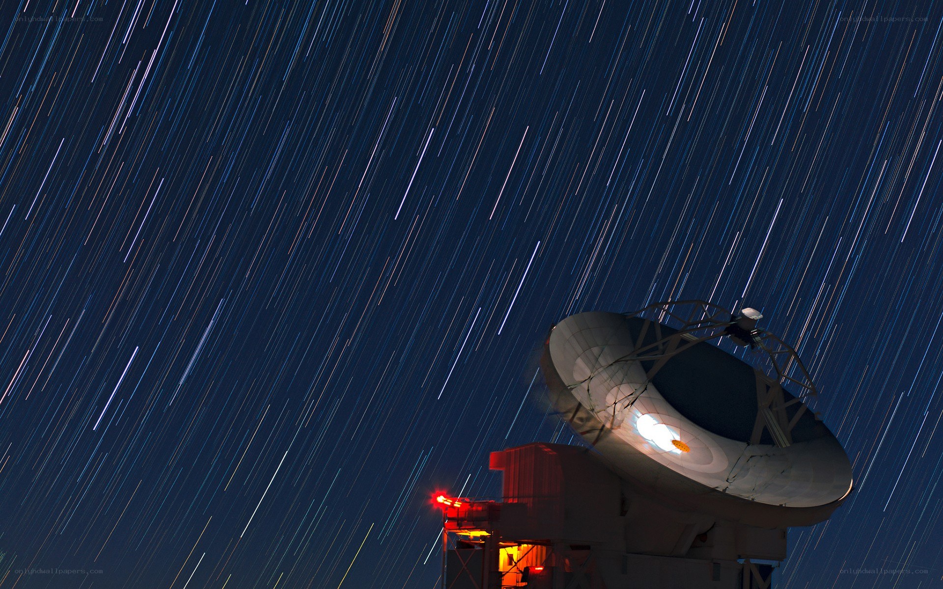 Star trails over radio telescope