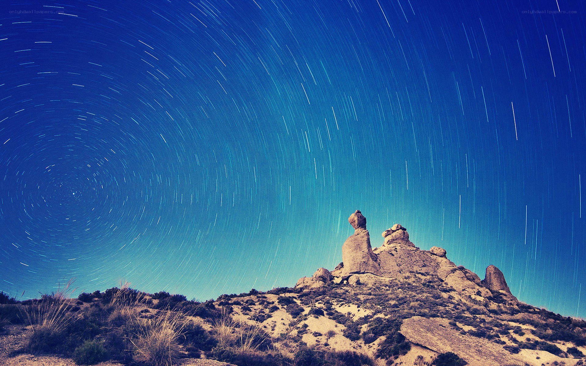 Star trails over rock formation