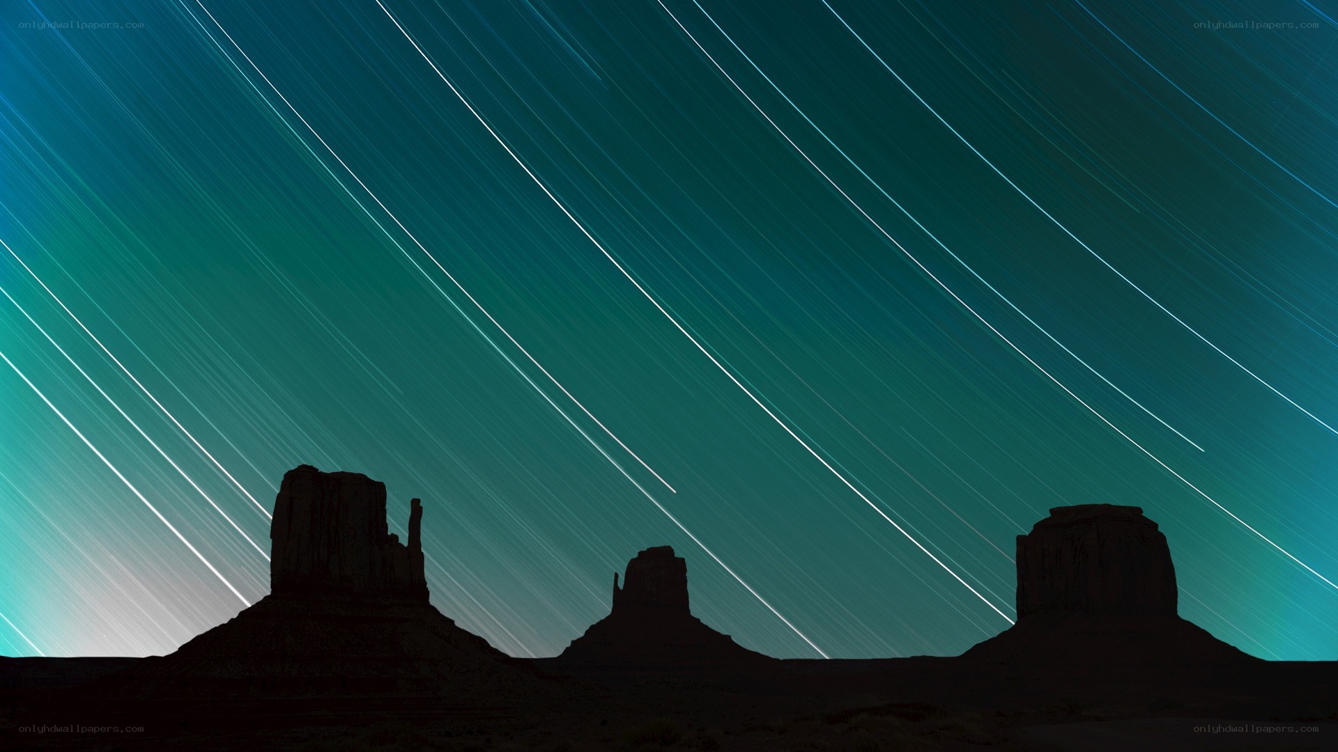 Star trails over rock formations